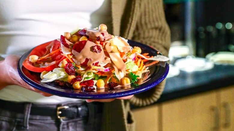 Person carrying a plate away from the Fire + Ice buffet