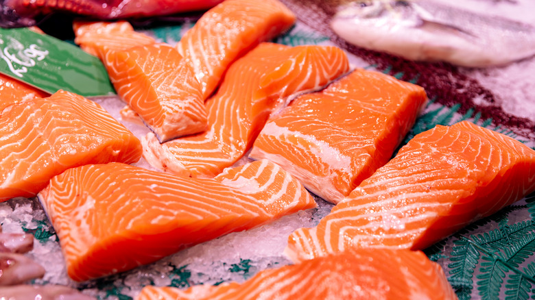 Salmon filets on a green-patterned surface