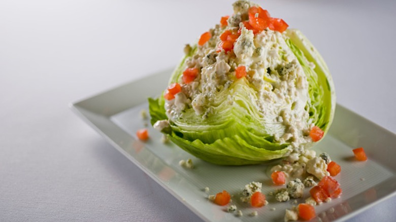 wedge salad on a rectangular white plate