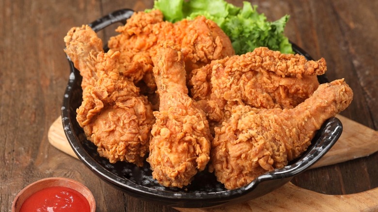 Crispy fried chicken on black plate