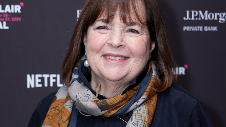 Ina Garten smiles in a scarf and pearl earrings at a Netflix event