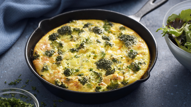 Broccoli and cheddar cheese frittata in cast iron skillet