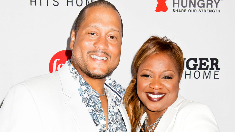 Pat and Gina Neely in white outfits, smiling at the camera at a press event