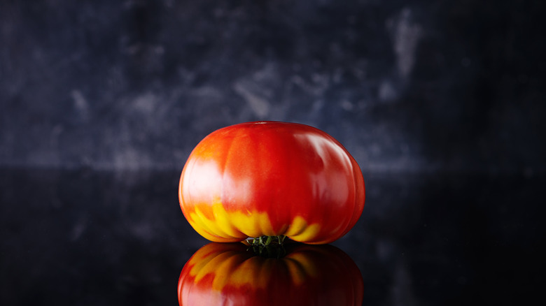 upside-down tomato on black counter