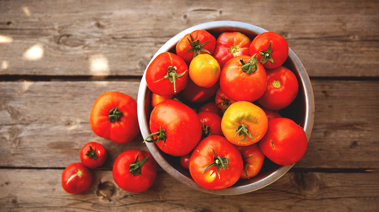bowl of tomatoes on wooden table