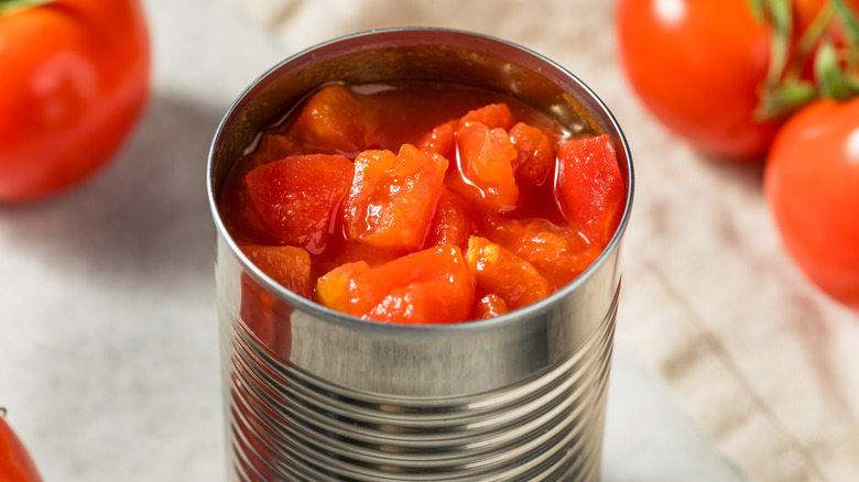 open metallic can filled with diced tomatoes