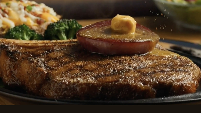Outback steakhouse steak with grilled onion on top.