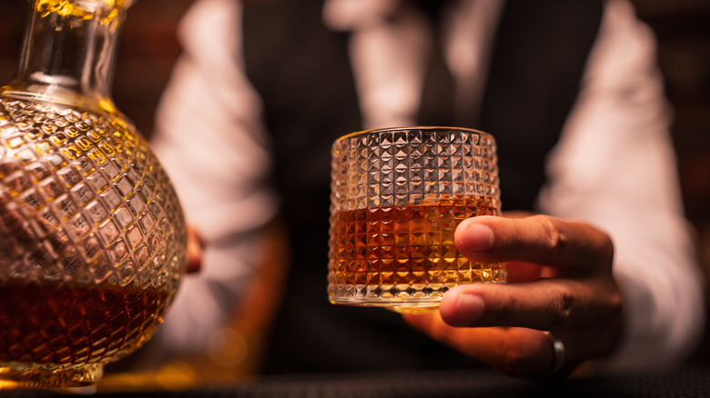 Bartender with a glass of whiskey