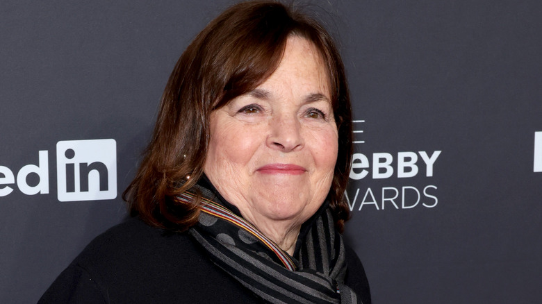 Ina Garten in gray and black scarf smiles at event