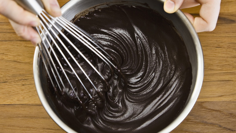 hands whisking chocolate