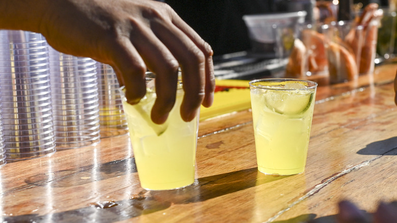 Two margaritas, one is being held