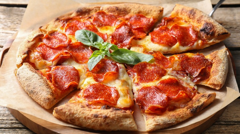 Pepperoni pizza with basil sprig