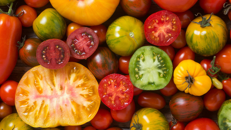 Close-up of assorted whole and cut heirloom tomatoes