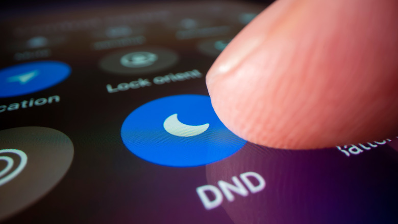 Someone pushing "Do Not Disturb" on cell phone