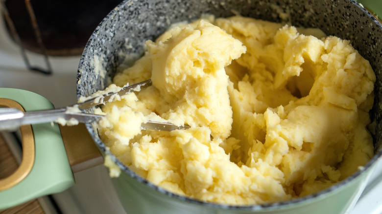 Mashing potatoes with a potato masher