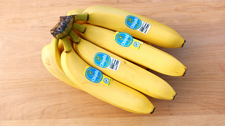 A bunch of Chiquta bananas on a wooden surface