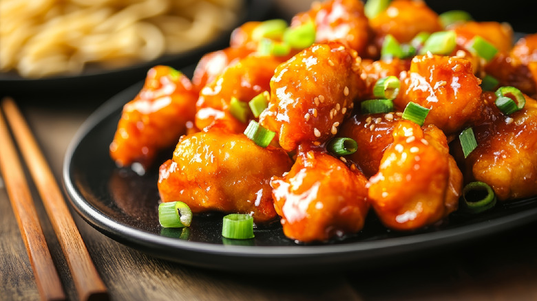Sweet-and-sour chicken with sesame seeds and green onions