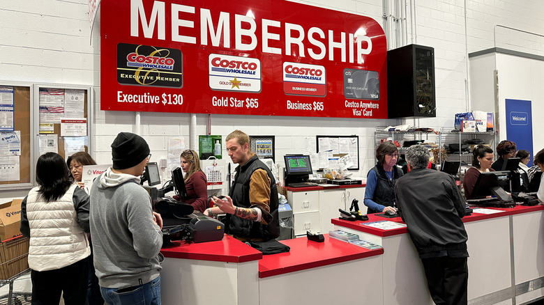 The Costco customer service desk with employees and customers gathered around it.