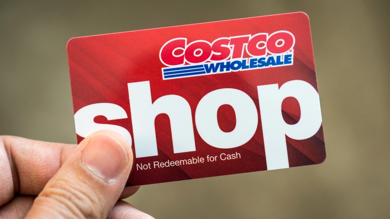 Person holding a red Costco Shop Card