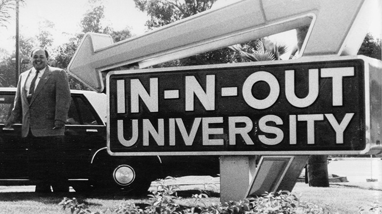 Rich Snyder standing beside a large sign for In-N-Out University