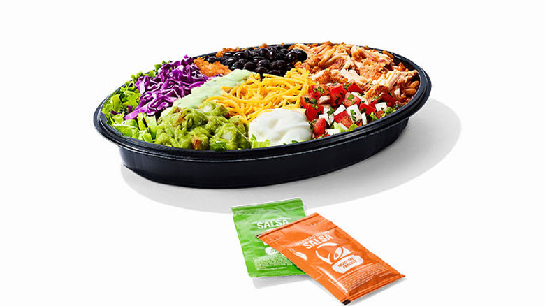 Taco Bell's Chicken Cantina Bowl with packets of salsa on the side