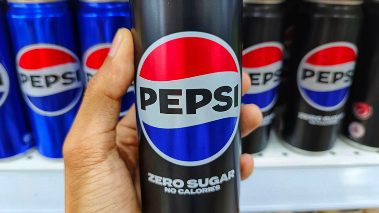 A hand holding Pepsi Zero Sugar