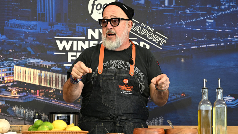 Andrew Zimmern giving a cooking demonstration at a Food Network event