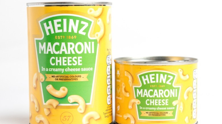 Two cans of Heinz macaroni and cheese in different sizes.