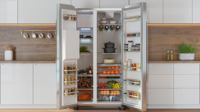 A large open fridge in a modern kitchen