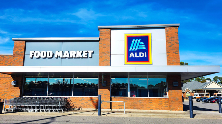 Outside of an Aldi supermarket with shopping carts lined up outside