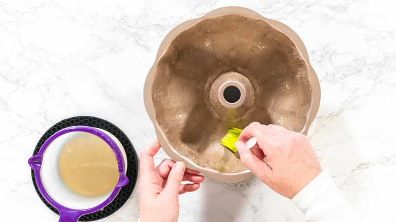 brushing oil into bundt pan