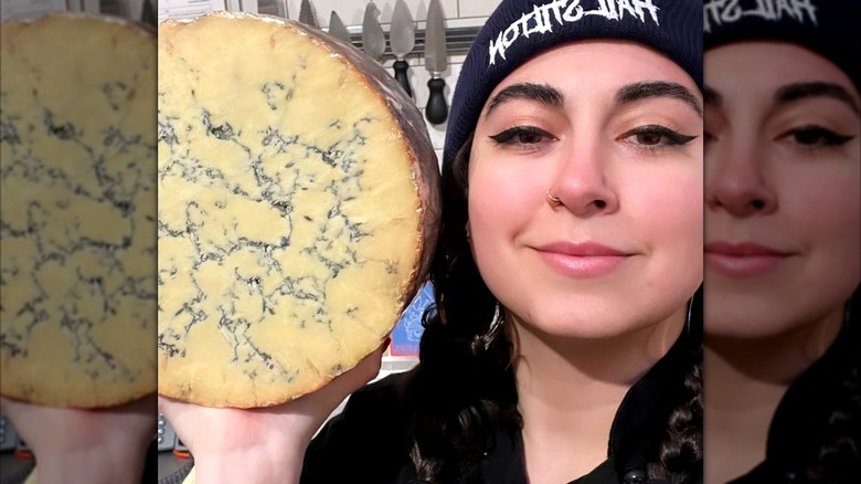 Emilia D'Albero poses with a round of stilton cheese