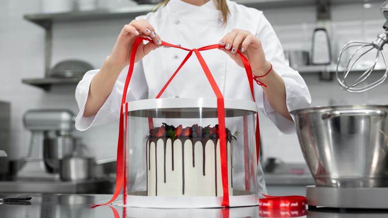 Iced cake being boxed for moving
