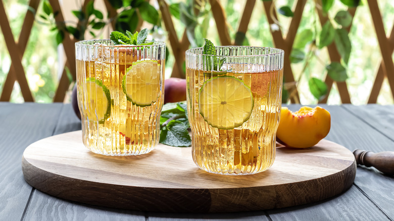 mocktails with peaches, lime wheels, and mint leaves
