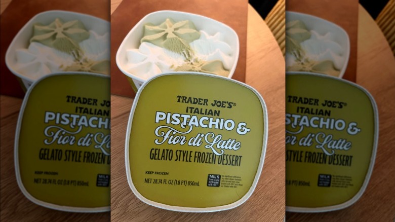 A tub of Trader Joe's Pistachio & Fior di Latte gelato with the lid off on a kitchen table.