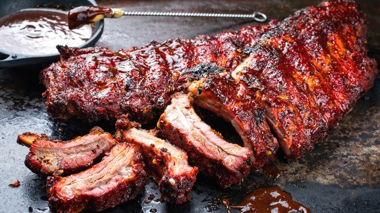 A rack of spare ribs brushed with barbecue sauce