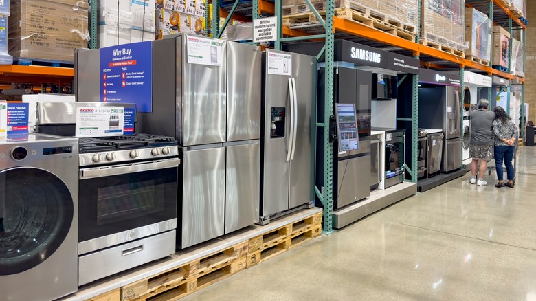 Appliances including fridges, ovens, and more displayed in Costco store warehouse