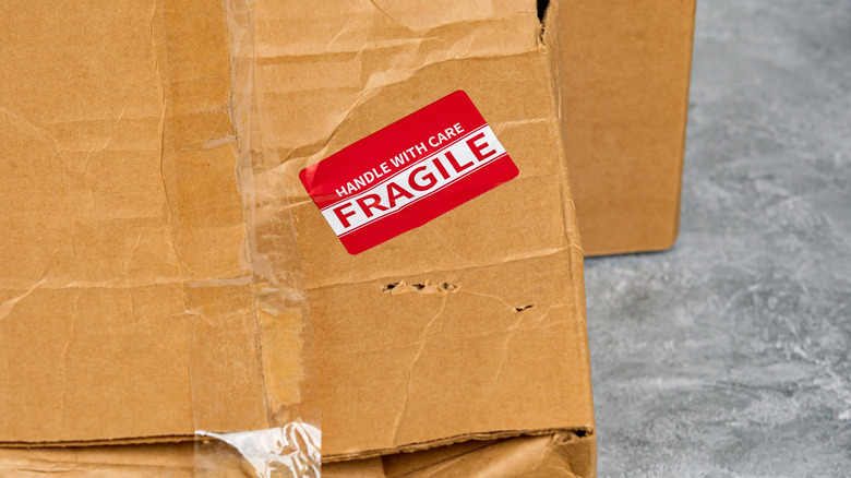 Damaged box with fragile sticker
