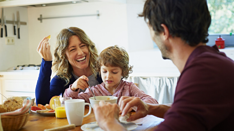 Happy family eating breakfast together