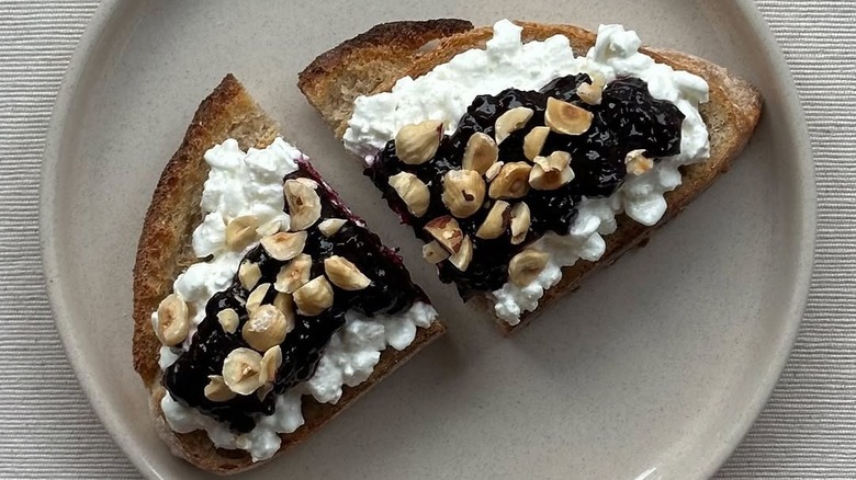 Sourdough toast with cottage cheese, jam, and hazelnuts