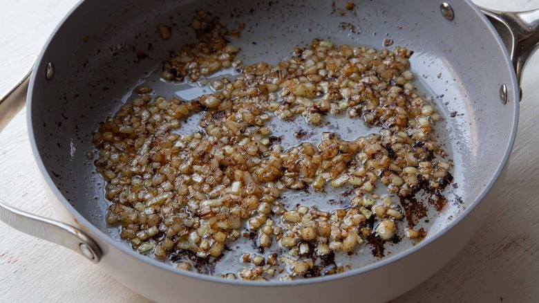 Diced onion cooking in pan