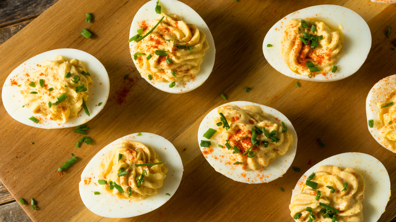 Deviled eggs on wooden cutting board