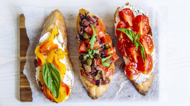 Colorful bruschetta with fresh vegetables on a cutting board