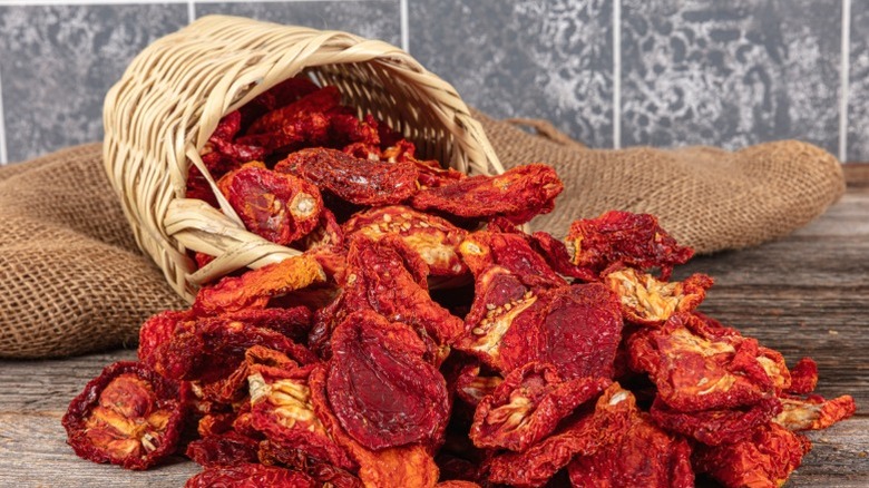 An overflowing basket of sun dried tomatoes.