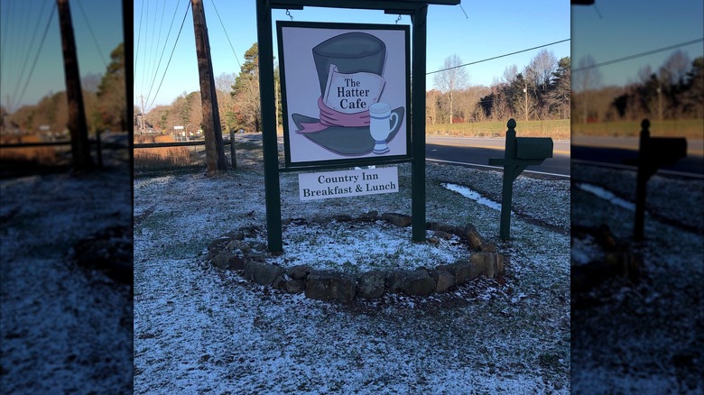 The Hatter Cafe exterior with sign showing Mad Hatter hat