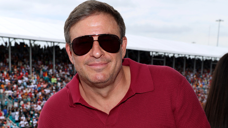 Raising Cane's Founder, Owner, and CEO, Todd Graves, wearing sunglasses at a large racing event