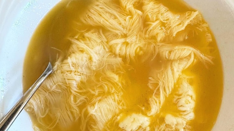 Su filindeu, or "threads of god," in a bowl of broth.