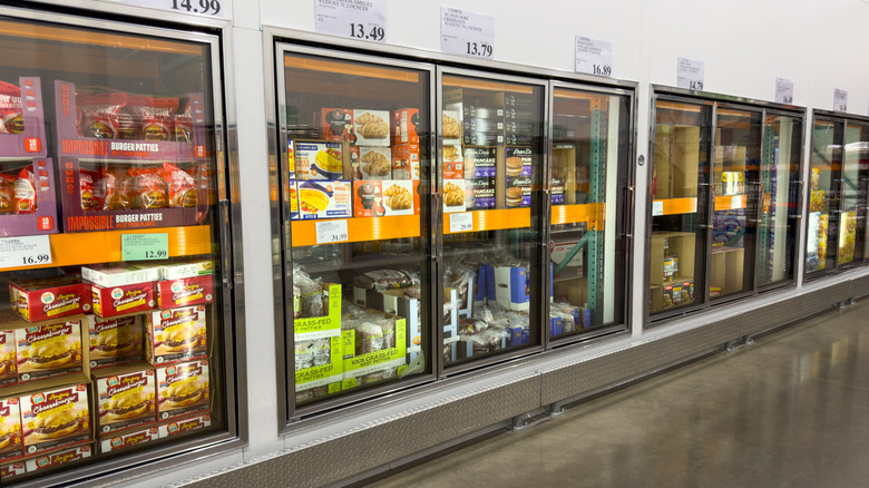 Refrigerators in Costco stocked with cold foods.