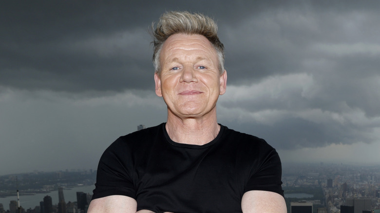 Gordon ramsay standing against the New York City skyline.