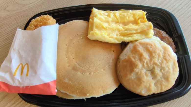 A McDonald's breakfast offering several menu items, including hotcakes, biscuits, eggs, and hash browns.